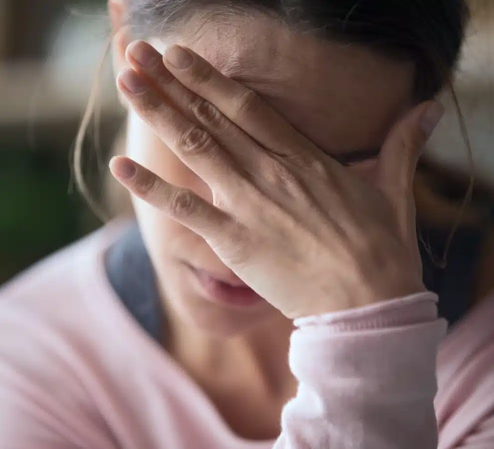 Stressed woman holding her head