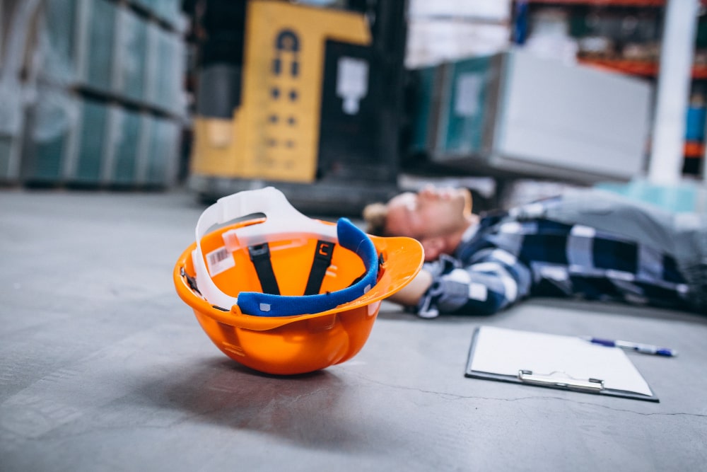 Man Laying On The Ground And A Construction Helmet Next To Him